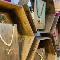 Necklaces presented on wooden display stands
